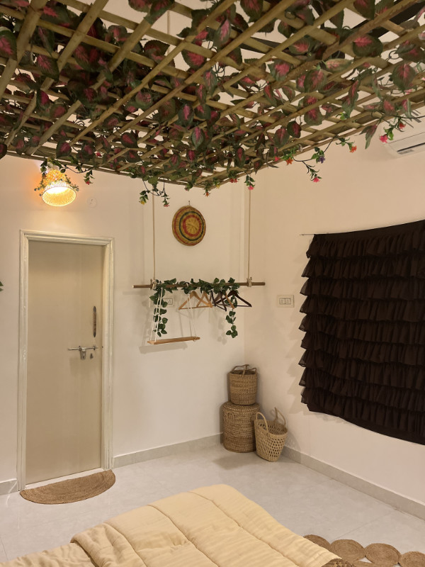 Cozy bedroom with rustic decor in a farm stay cottage near Bangalore city limits