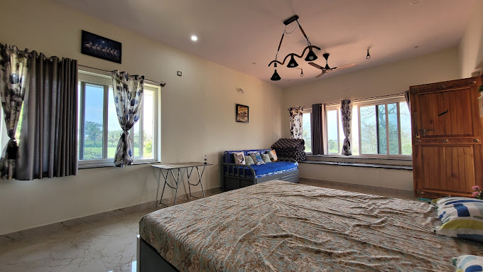 Cozy first-floor rooms at RatnaPrabha Farm